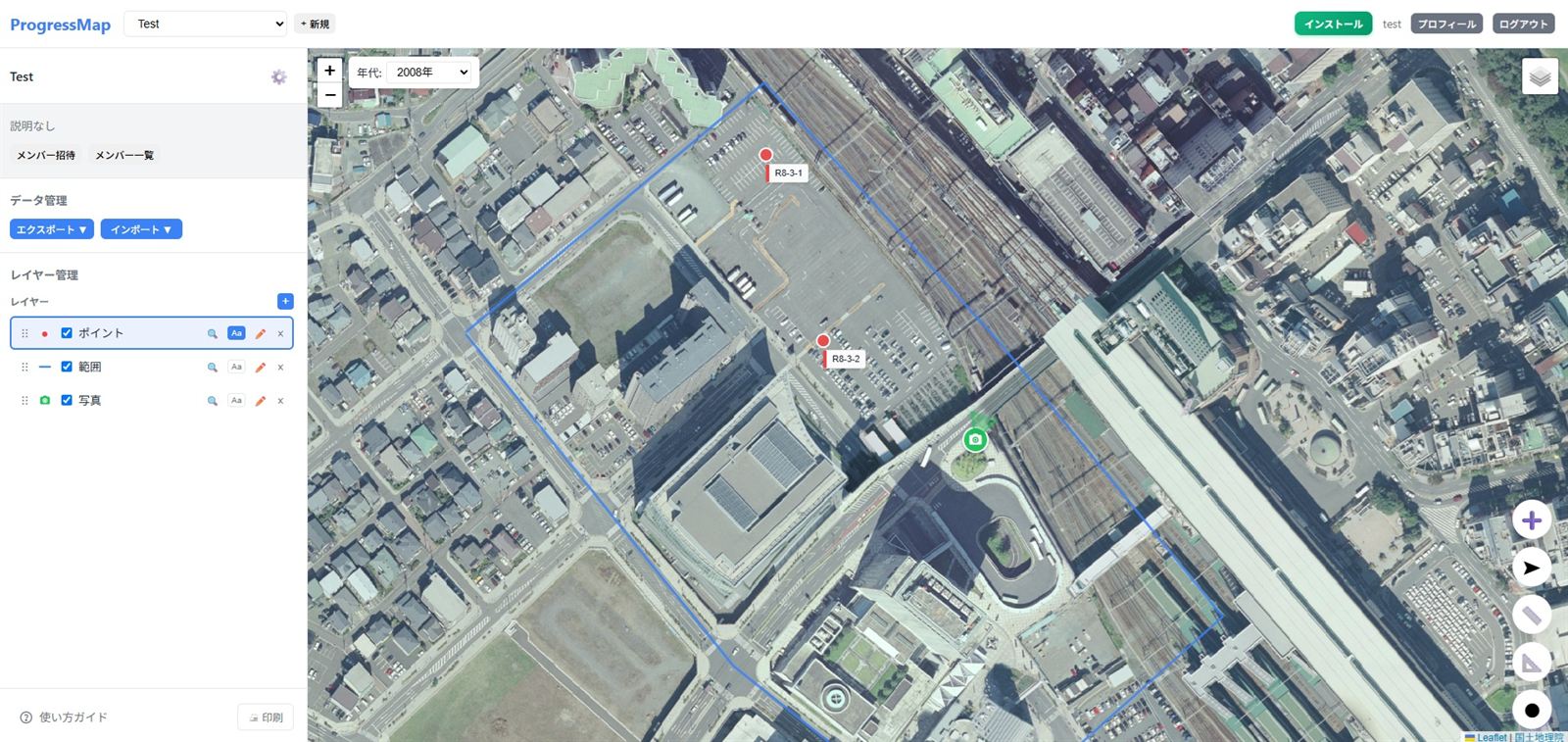 ProgressMapのPC画面。航空写真の上にポイント・範囲の線・写真マーカーが表示され、左にレイヤー管理のサイドバー、地図上部に航空写真の年代セレクタがある